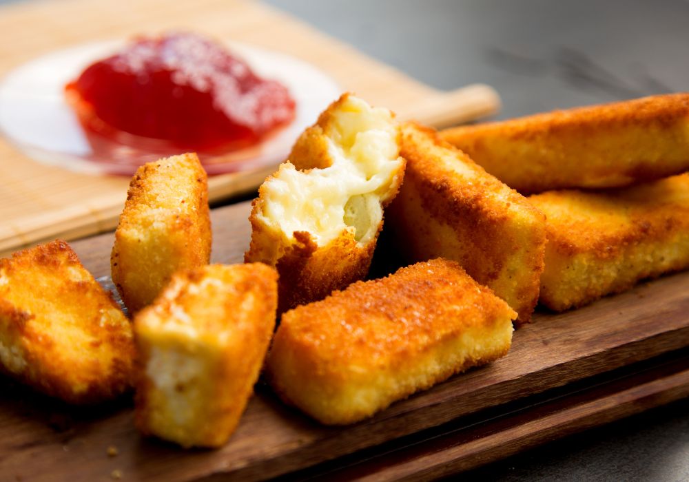 Pieces of deep fried brie with jam.